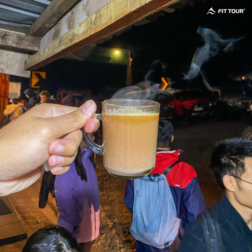 Du khách chụp ảnh ly cafe sửa buổi sáng cho ngày sớm ở chân núi Bromo